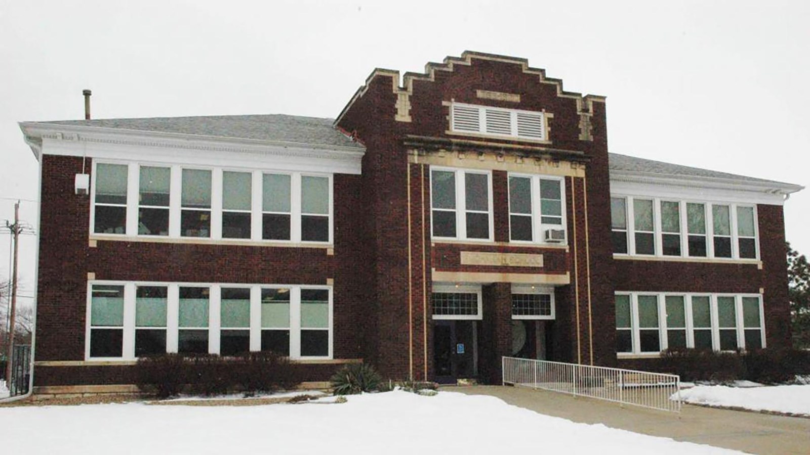 Brick building with large rectangular windows across most of it\'s face.