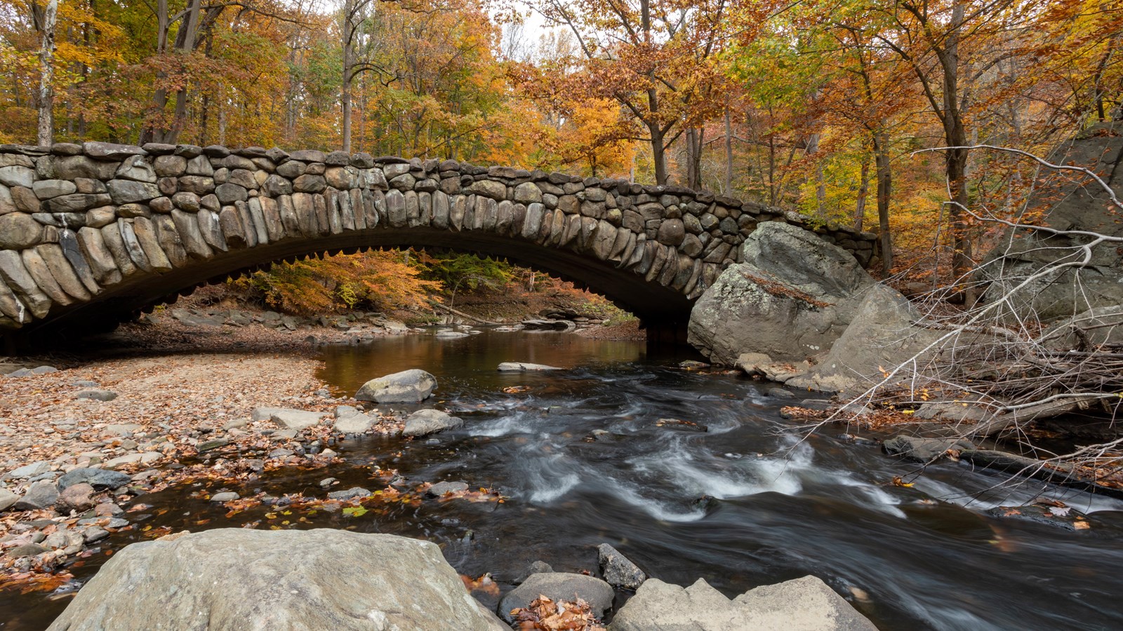 A stone bridge over a rushing river