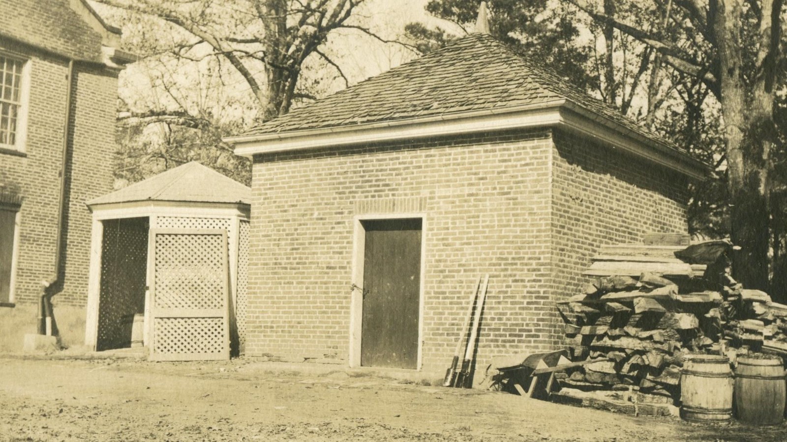 Small brick building with one wooden door and no windows.