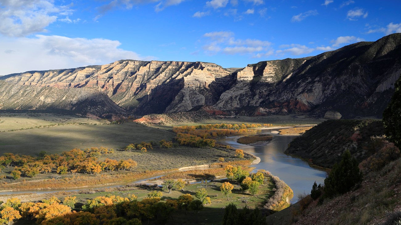 The Green River twists through a landscape of canyons and yellowing trees at Island Park.