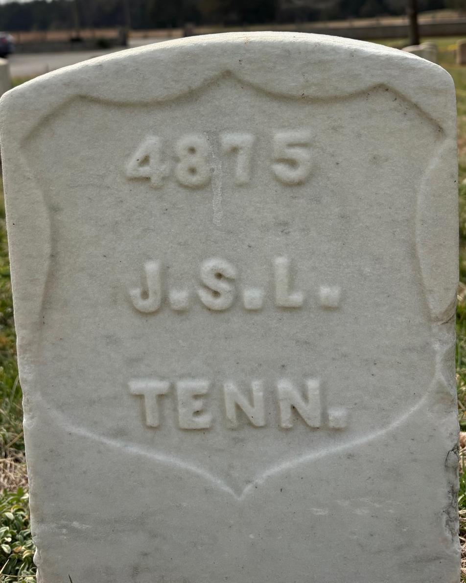 Marble headstone with the initials "J.S.L" inscribed in it. 