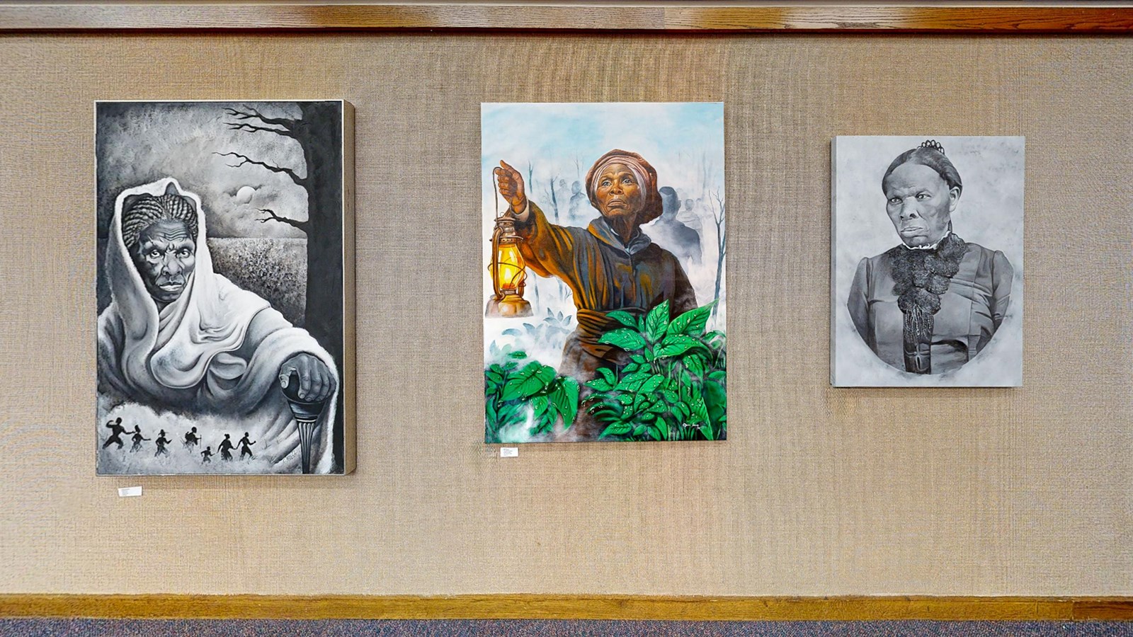 Three paintings of Harriet Tubman on display at the Harriet Tubman Freedom Center.