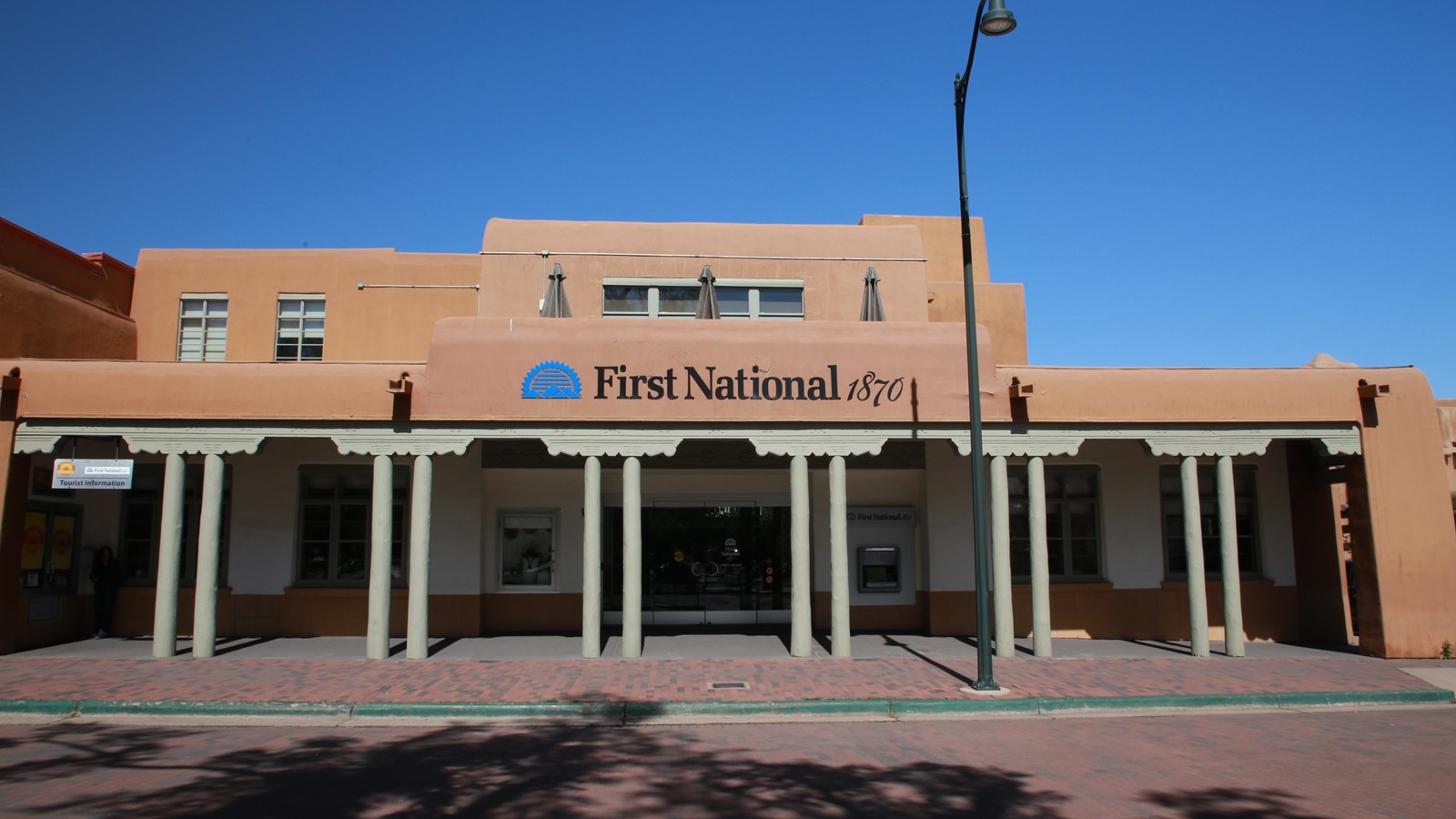A large pink, spanish style adobe building.