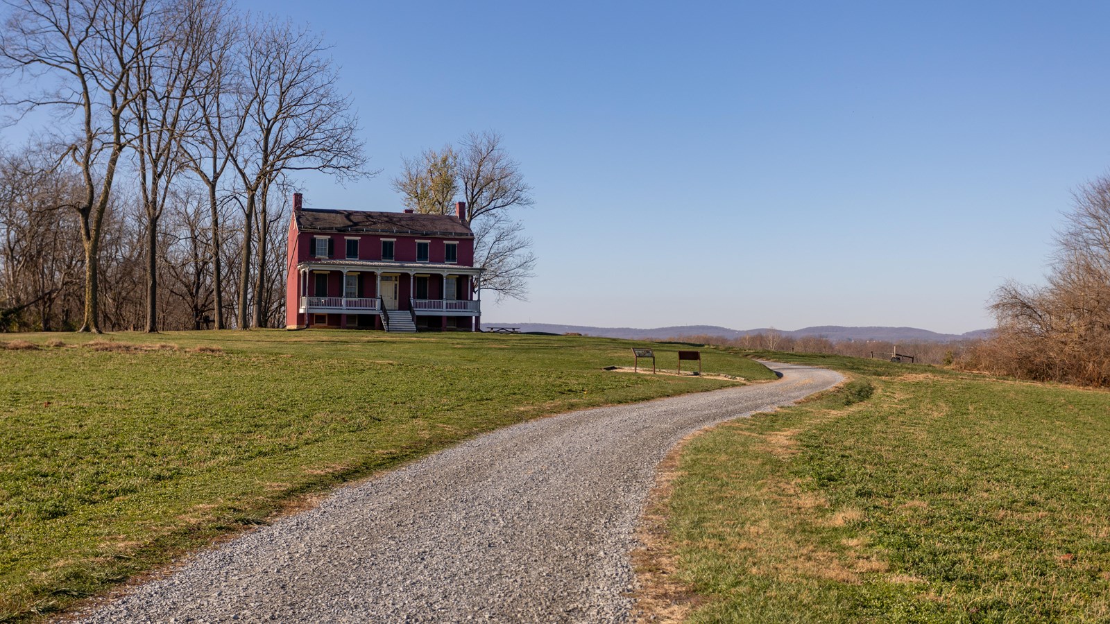 a farm at the end of a long curving road