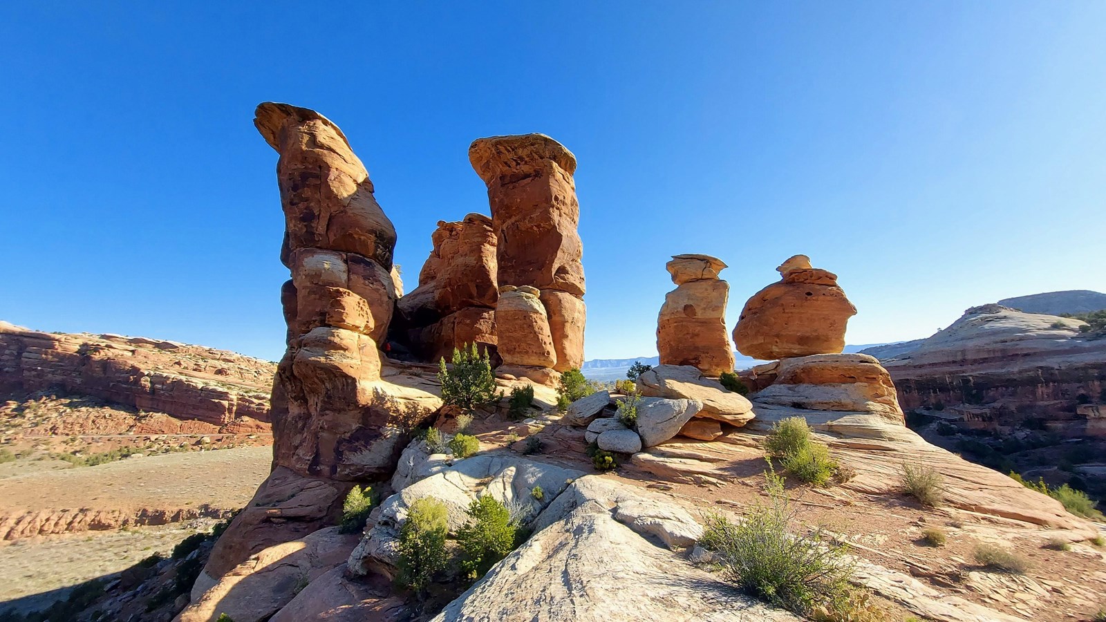 red-orange sandstone towers and boulders with an open blue sky