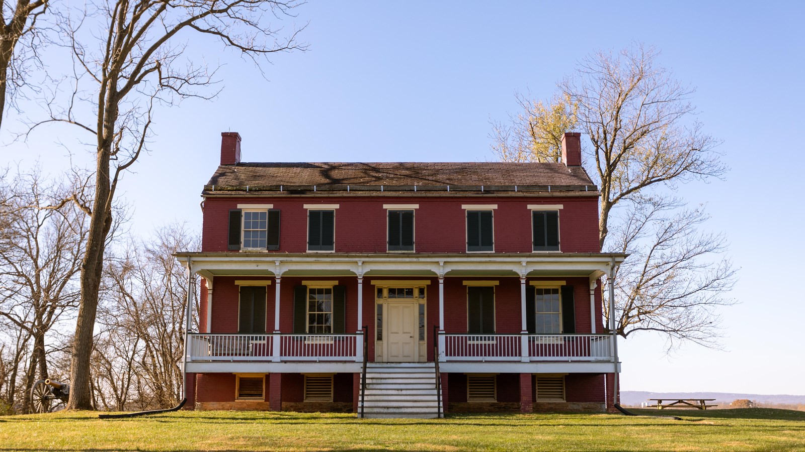 A large two story red house. 