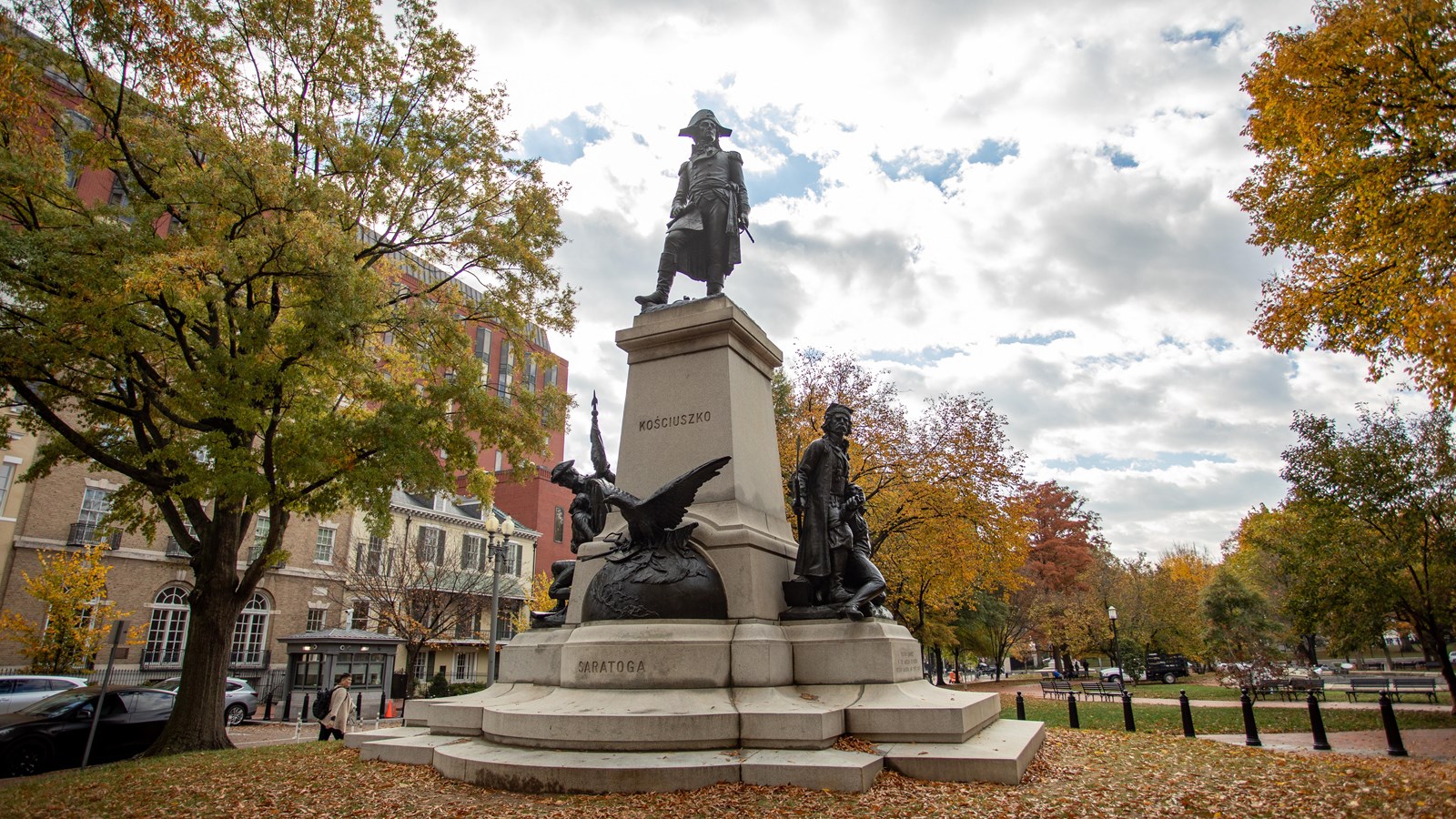 A bronze sculpture of Thaddeus Kosciuszko atop a stone plinth with an eagle and soldiers.