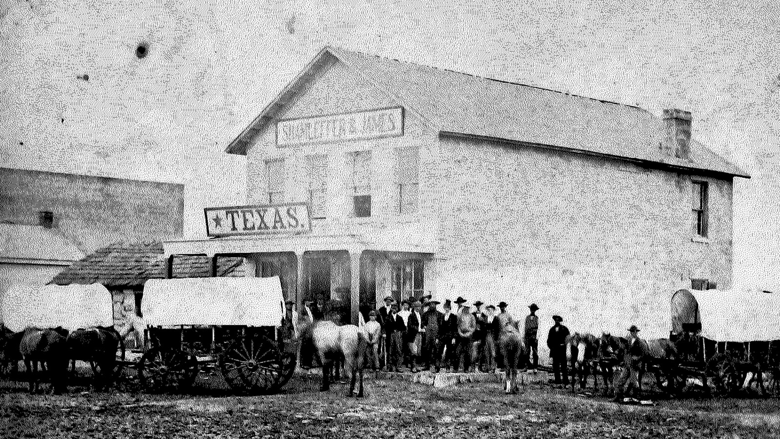 Two-story stone building shaped like two rectangles side by side with the right side.