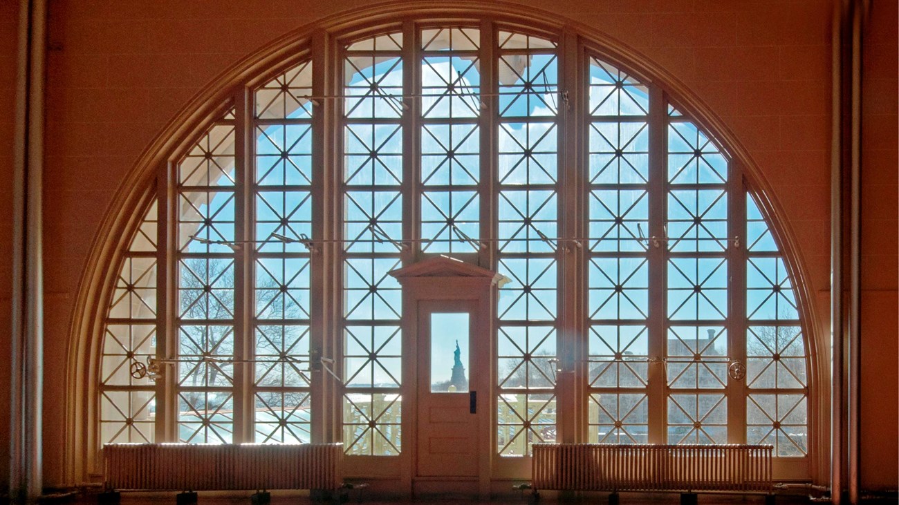Windows on second floor great wall showing Liberty through the door window.