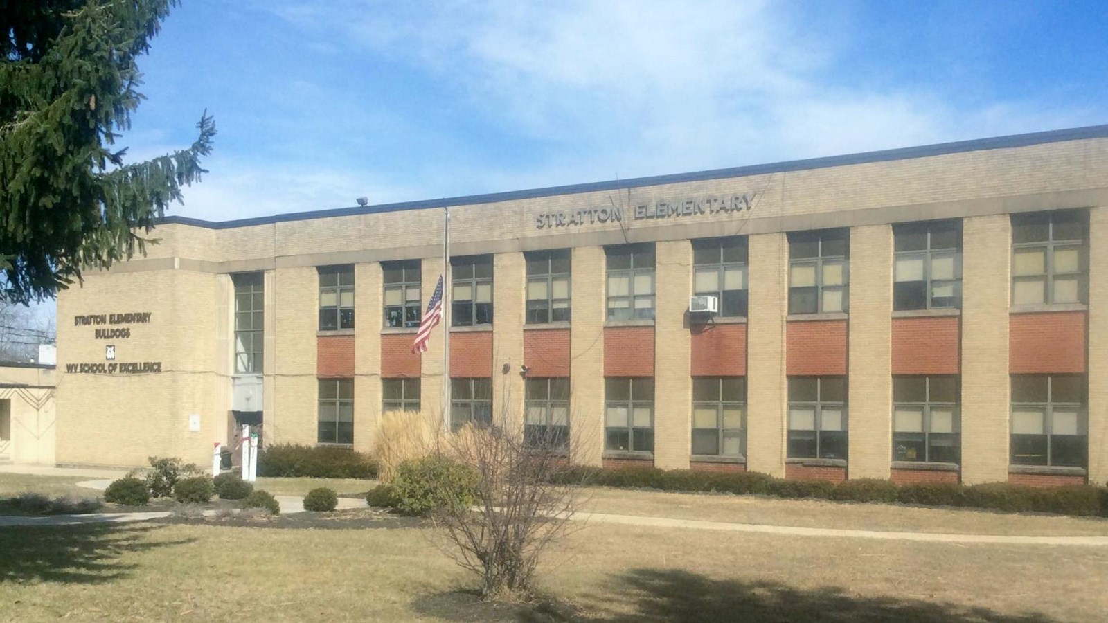 A large, two story school building. 