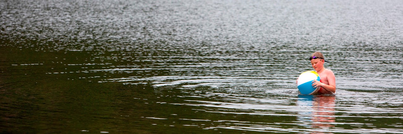 Child with an inflatable toy in a lake