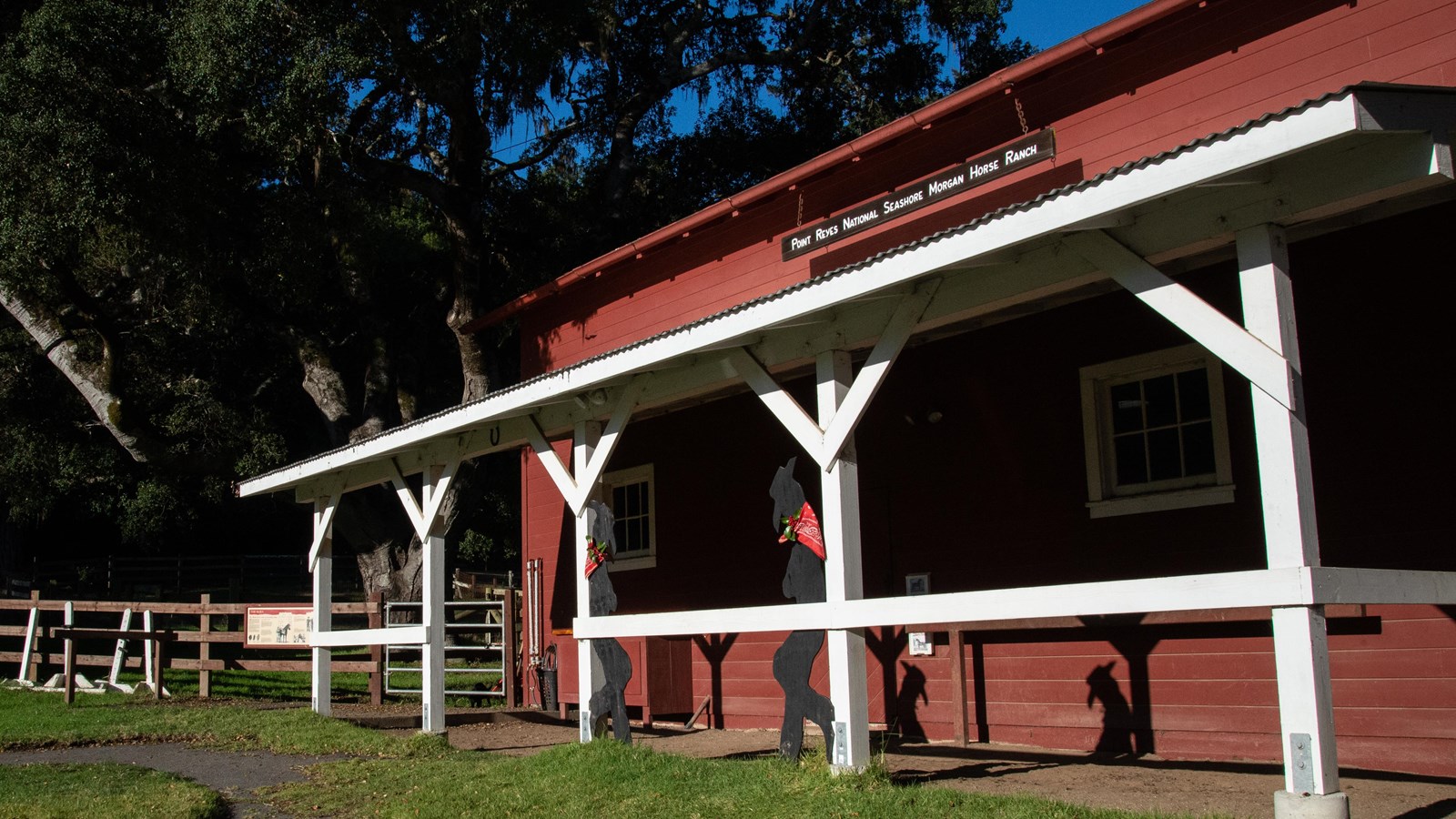 Red barn with white trim, and a sign that says Point Reyes National Seashore Morgan Horse Ranch.