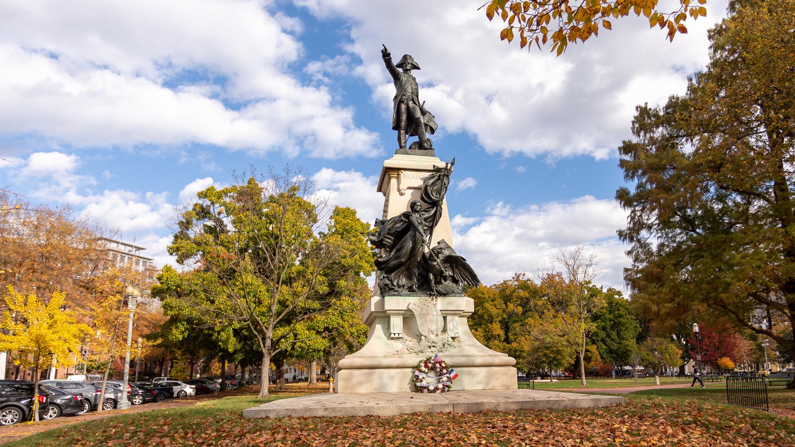 Bronze statue of Gen. Rochambeau in Revolutionary War attire atop a plinth.