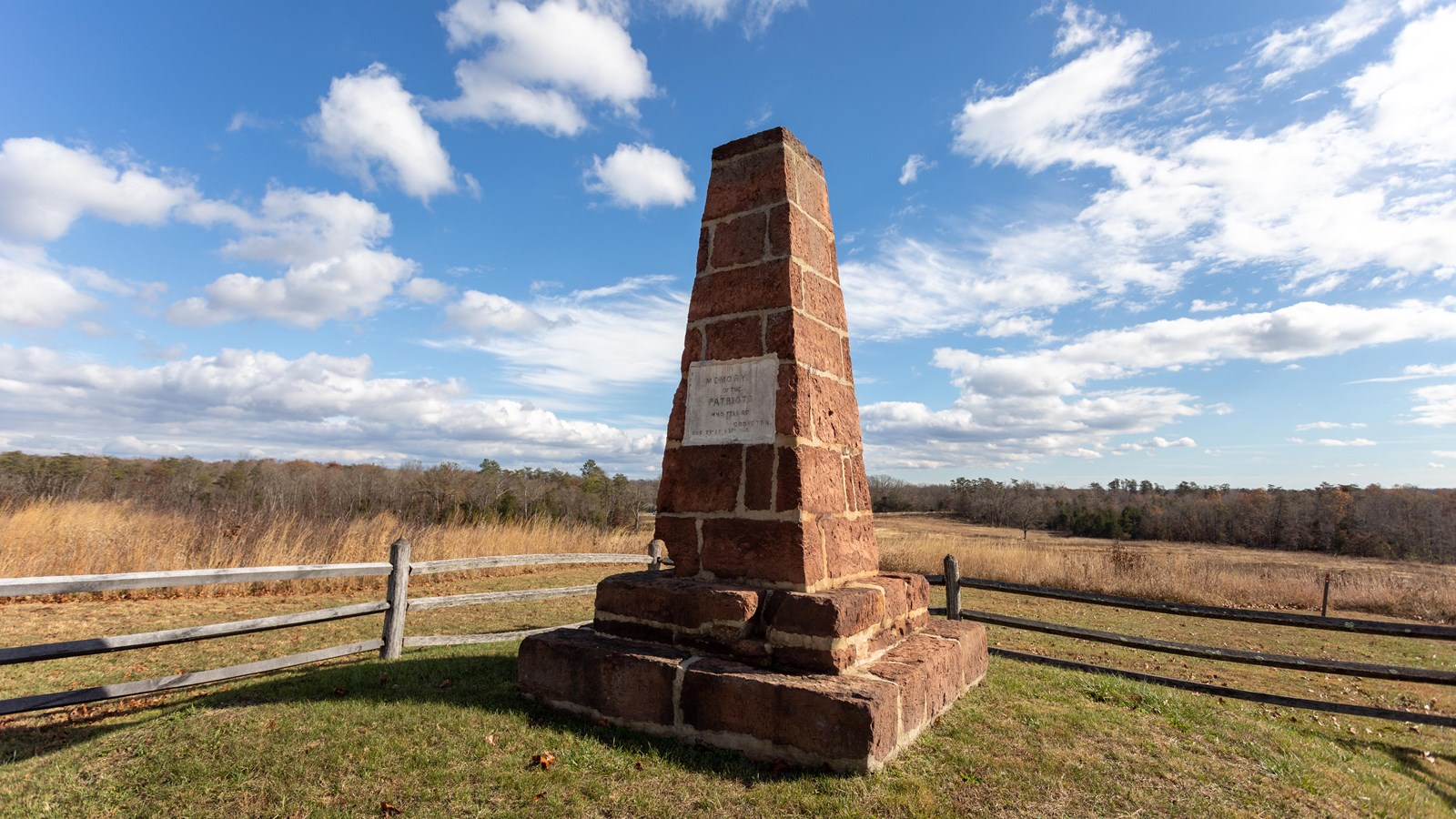 A large stone monument in a field.