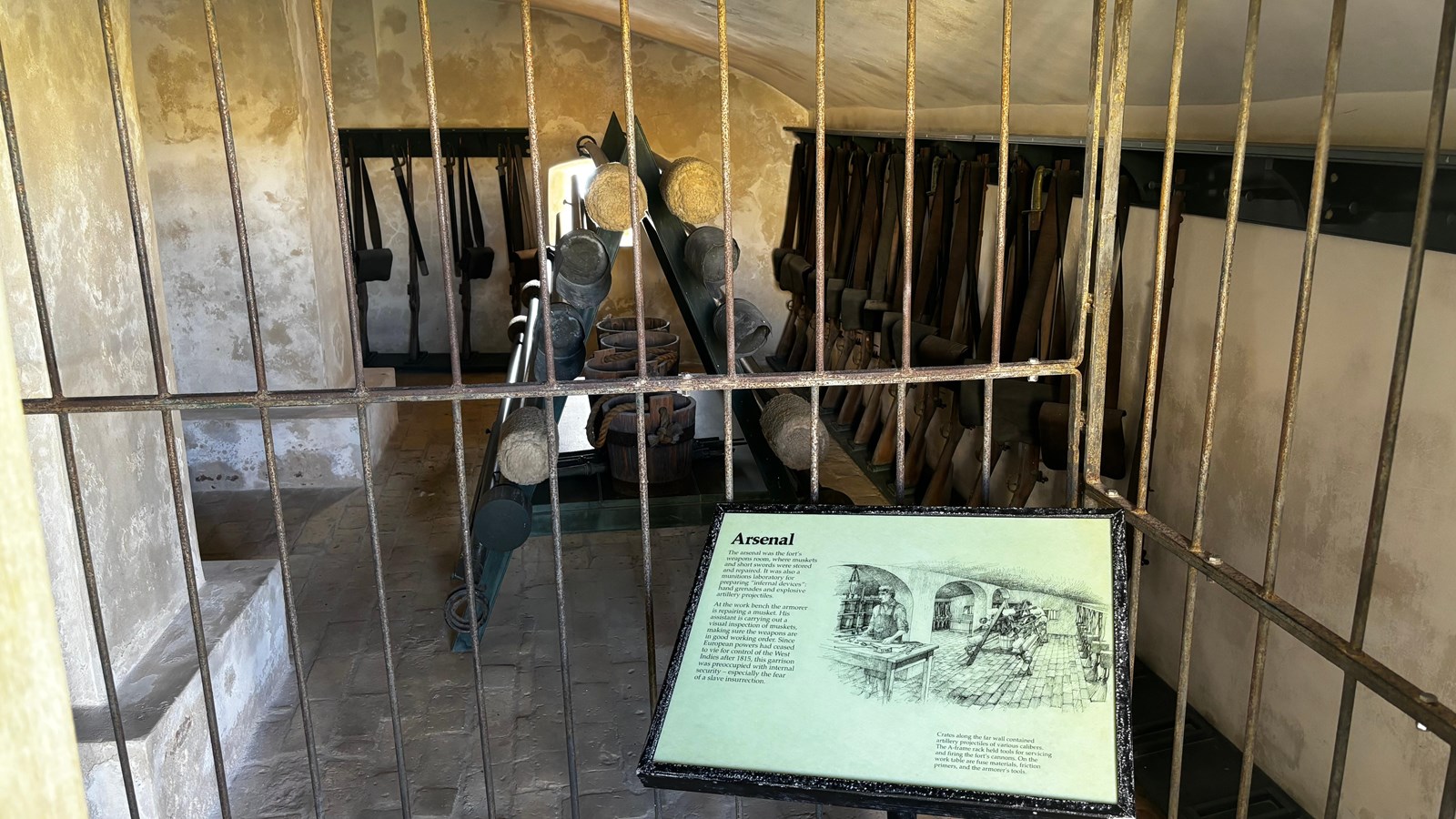 Photo of barred room with guns lining the walls.