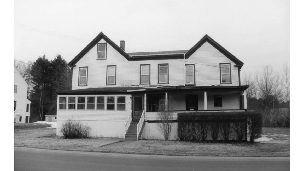 two-story, wood-framed rectangular house with a porch 