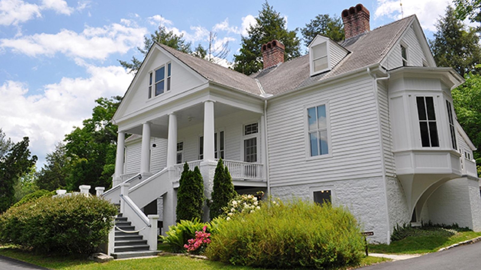 Historic 3 story white home sits on a hill