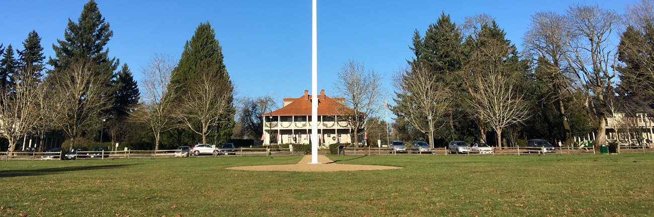 The American flag flies on the Parade Ground flagstaff on a sunny day.