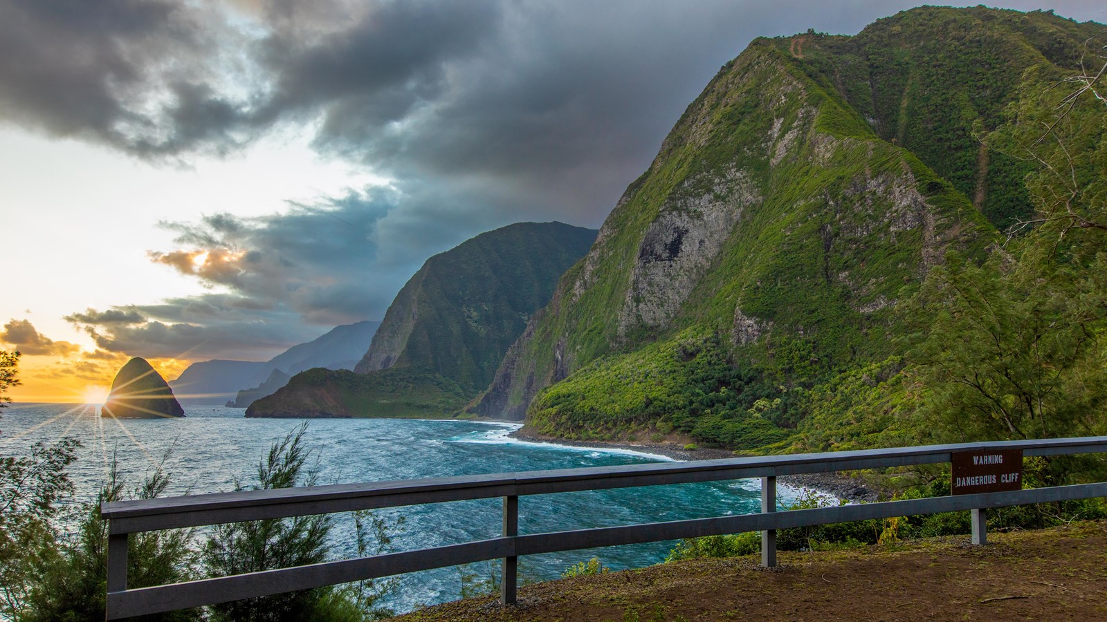 The ocean and sea cliffs during a sunrise.