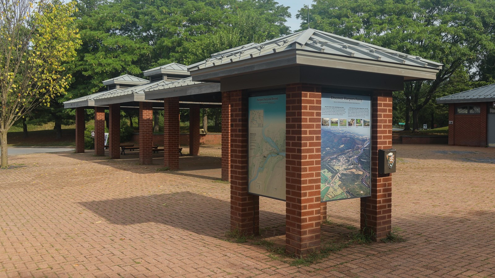 A brick kiosk with information panels on each of four sides.