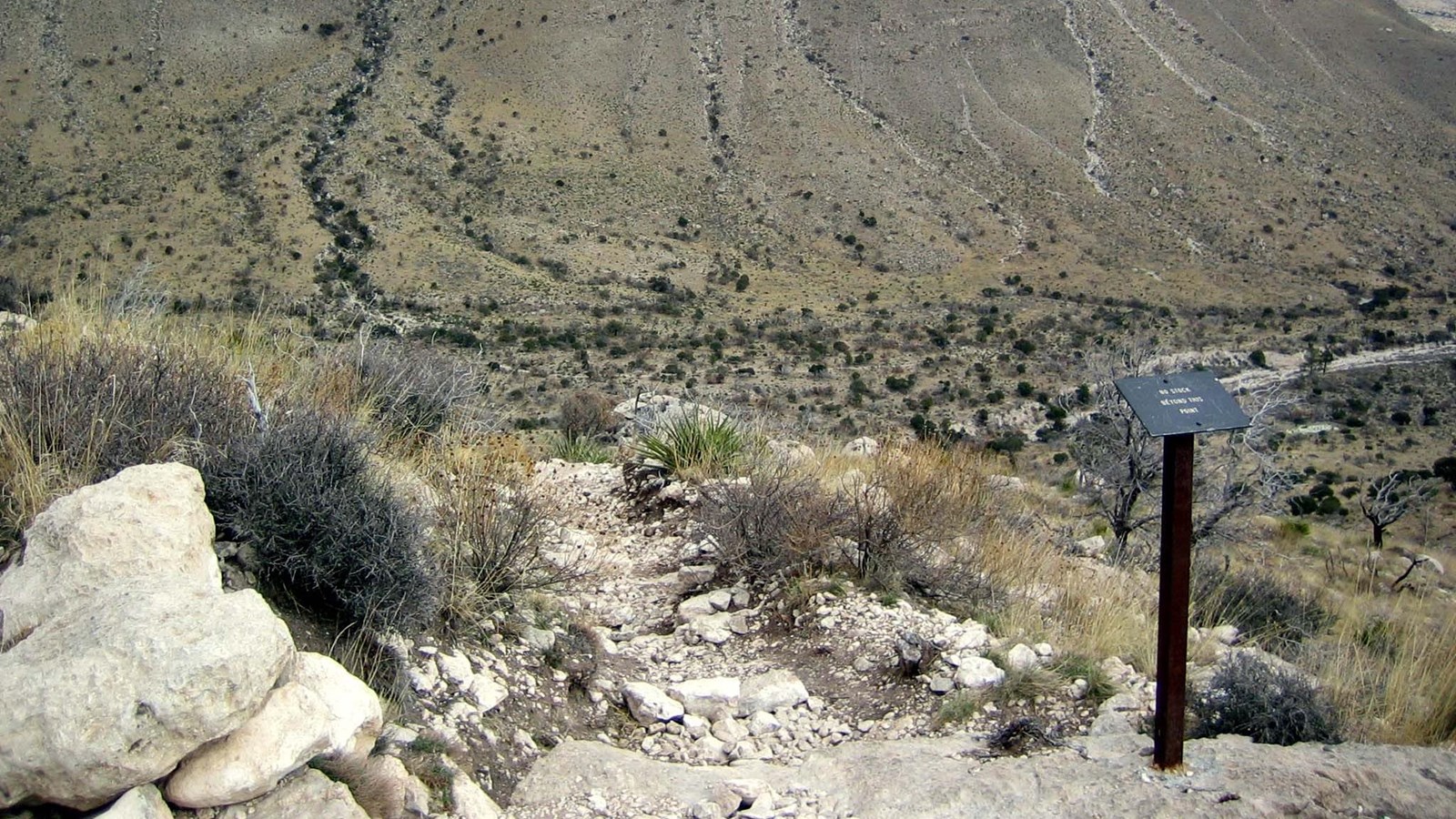 A trail junction overlooking a wide canyon mouth