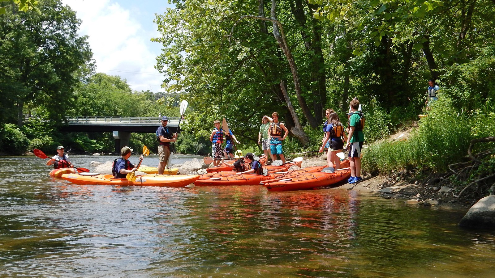 A group of paddlers launches their canoes into the Cuyahoga River.