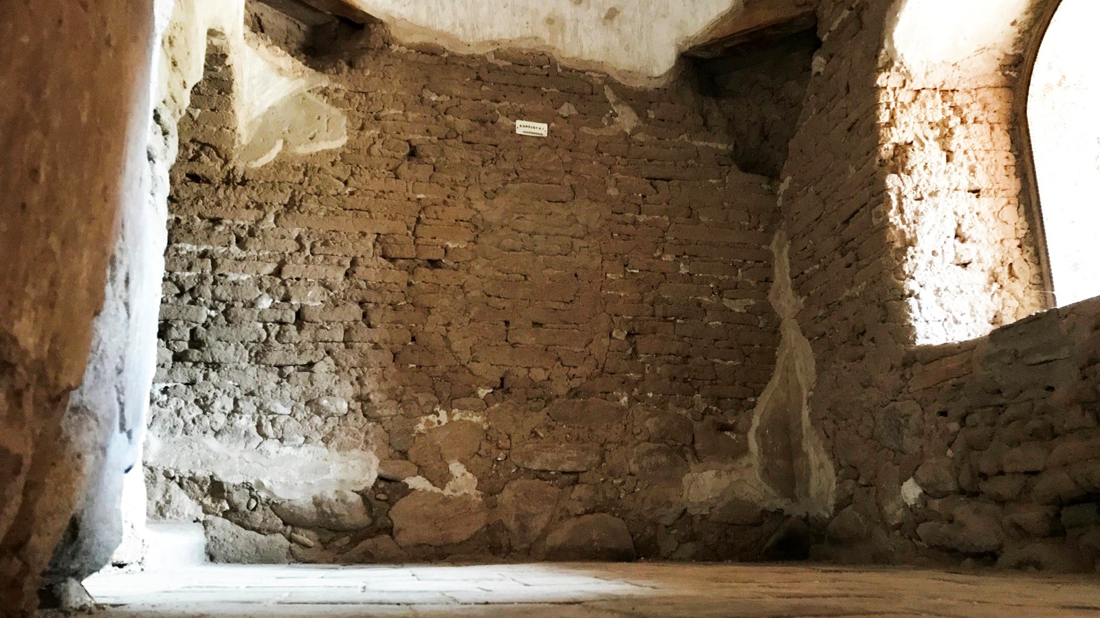 panoramic image of baptistry room with staircase to the right, window to the left, and passageway