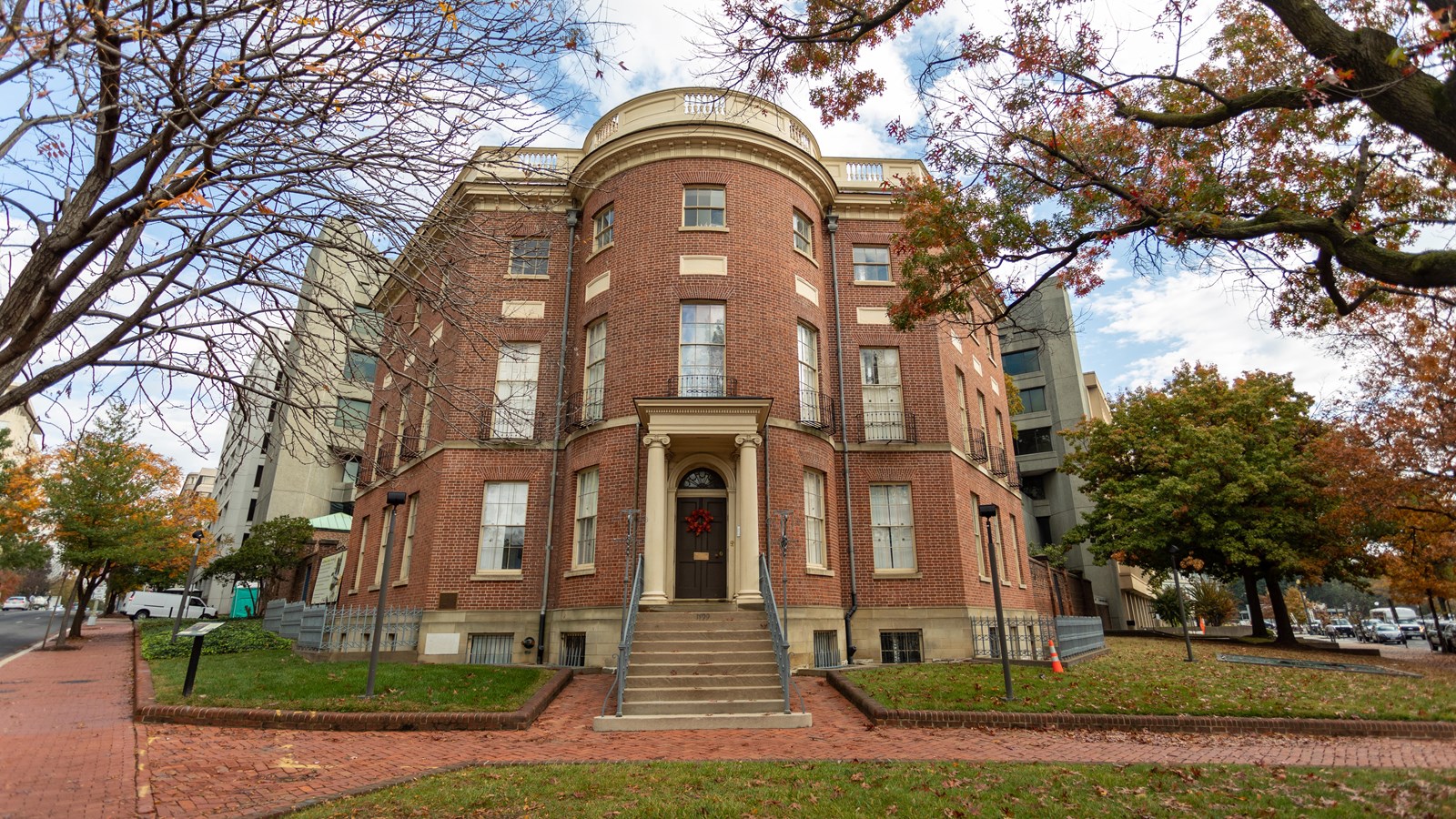 A three-story brick building with octagonal turret feature at front door.