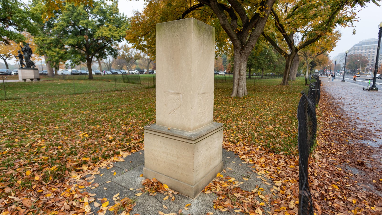 A seven foot tall limestone monument with an inscription.