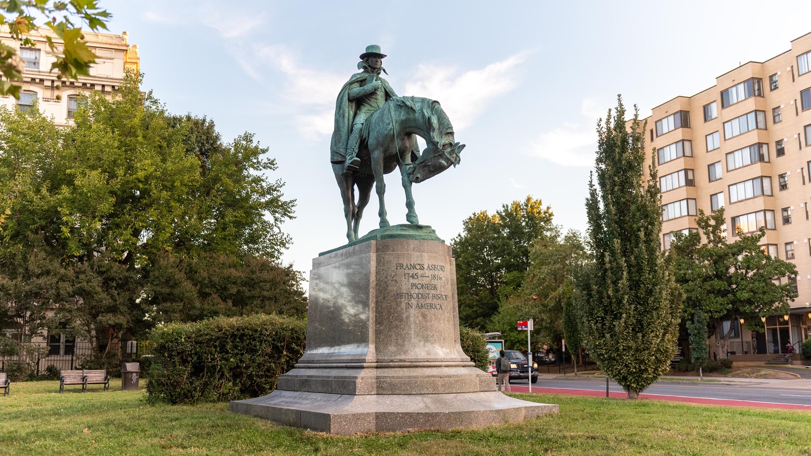 A large statue of a soldier on a horse in a city.