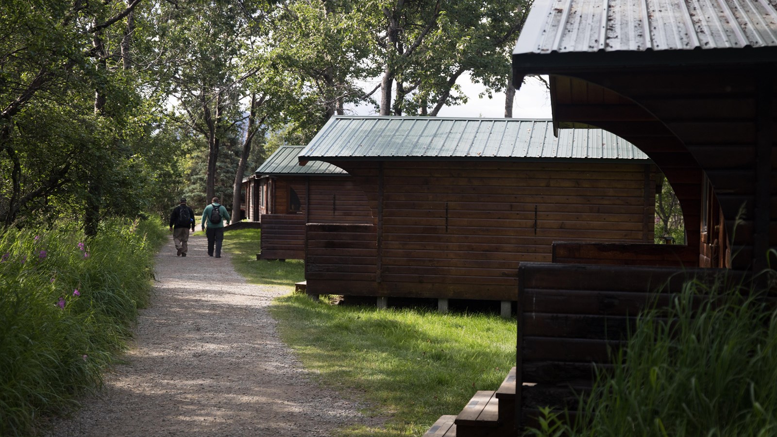 Several small buildings along a gravel path