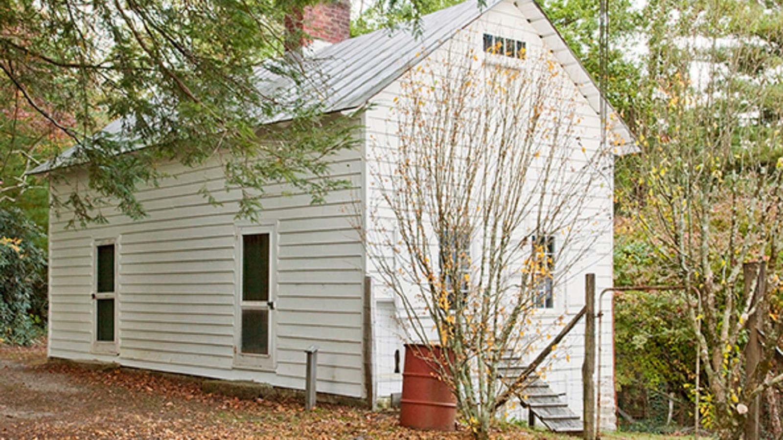 White building with doors and windows with a fence surround