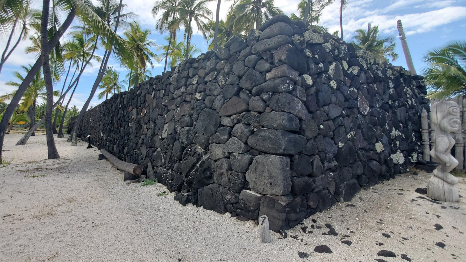 The corner of the great wall with stacked interlocking lava rock stones 10 feet in height.