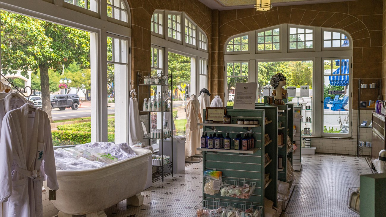 Large rounded windows behind display cases of souvenirs