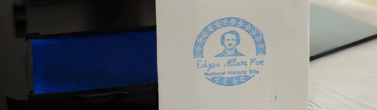Color image featuring a piece of white paper with an Edgar Allan Poe stamp.