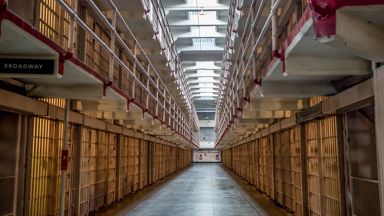 A open hall extended between 2 rows & 3 tiers of cells. Skylights let in light overhead.