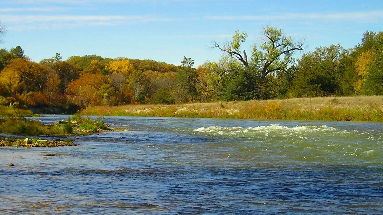 A river flows and rapids stretch the middle of the channel.