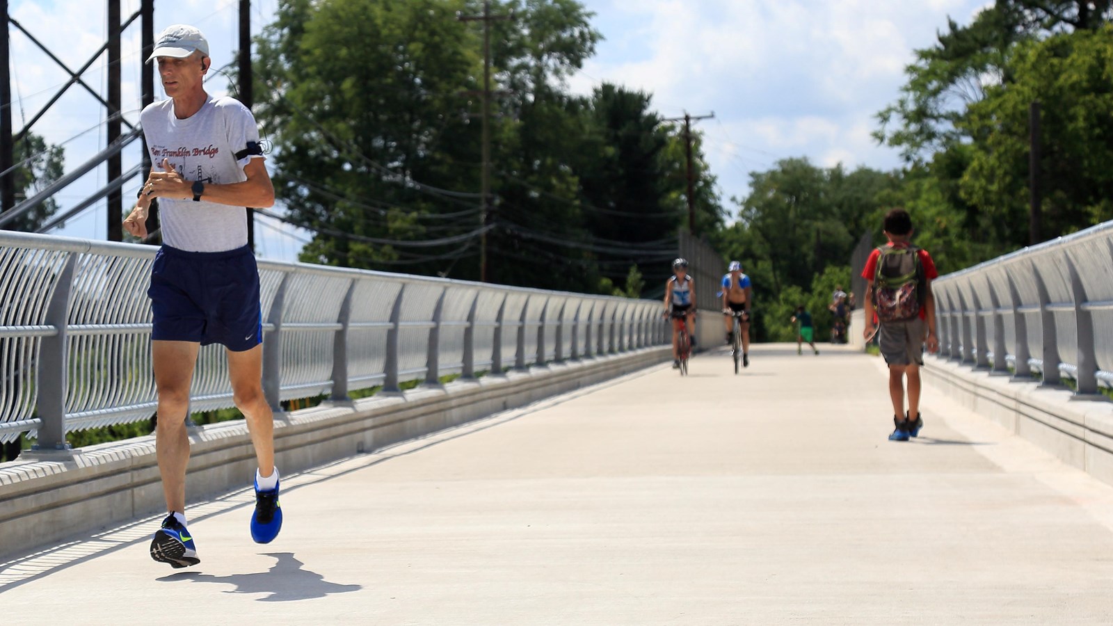 outdoors, pavement, metal railings, bridge, running, walking, biking