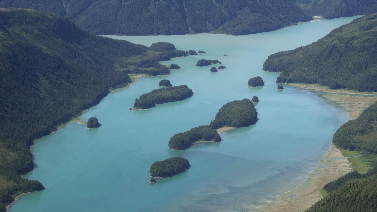 An aerial view of the calm waters and small islands of Dundas Bay.
