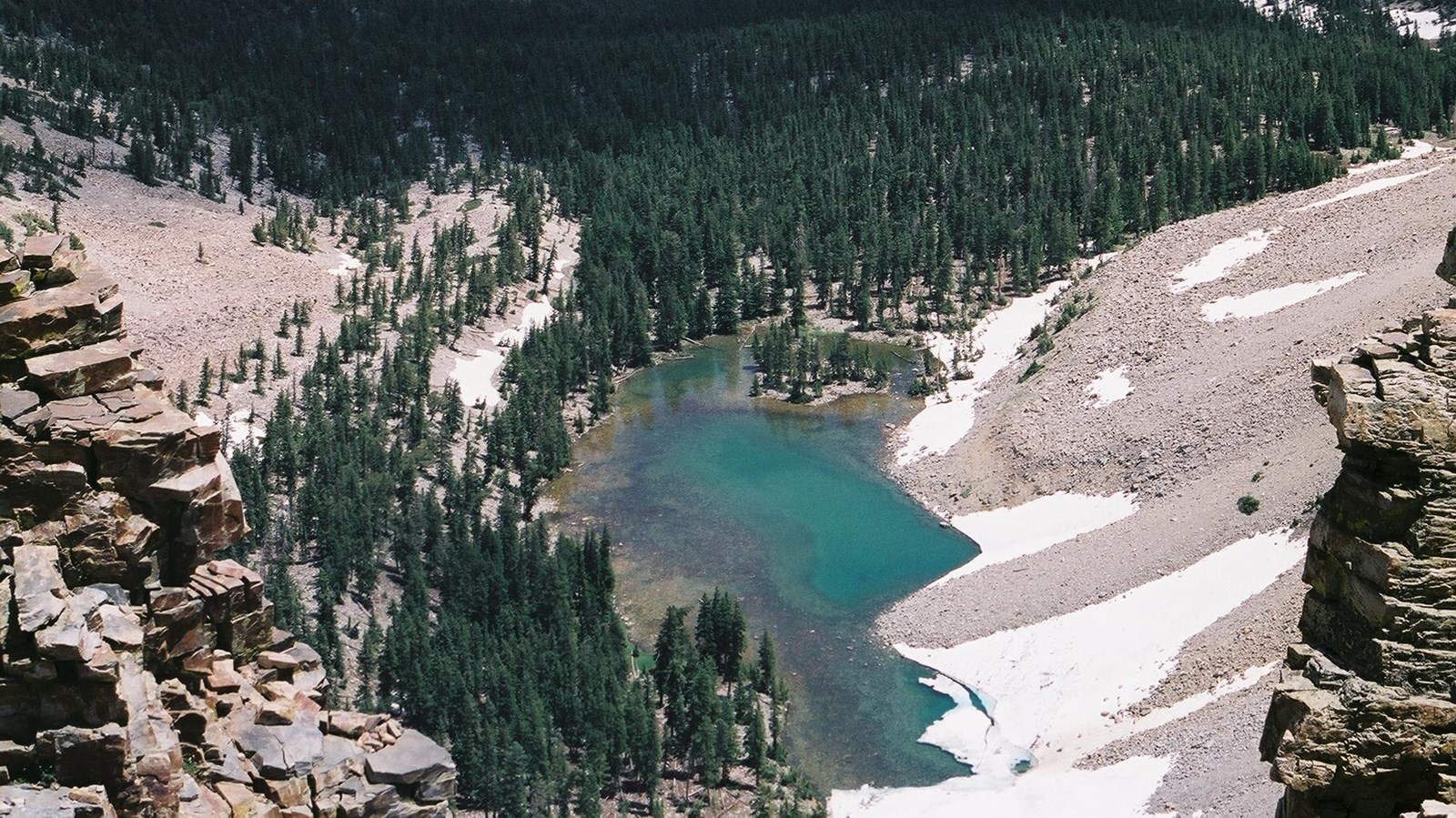 Baker lake viewed from above with trees sounding a blue lake.