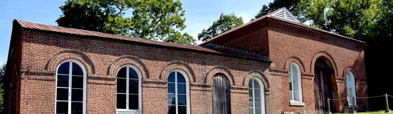 Image of large brick trolley barn viewed from the front