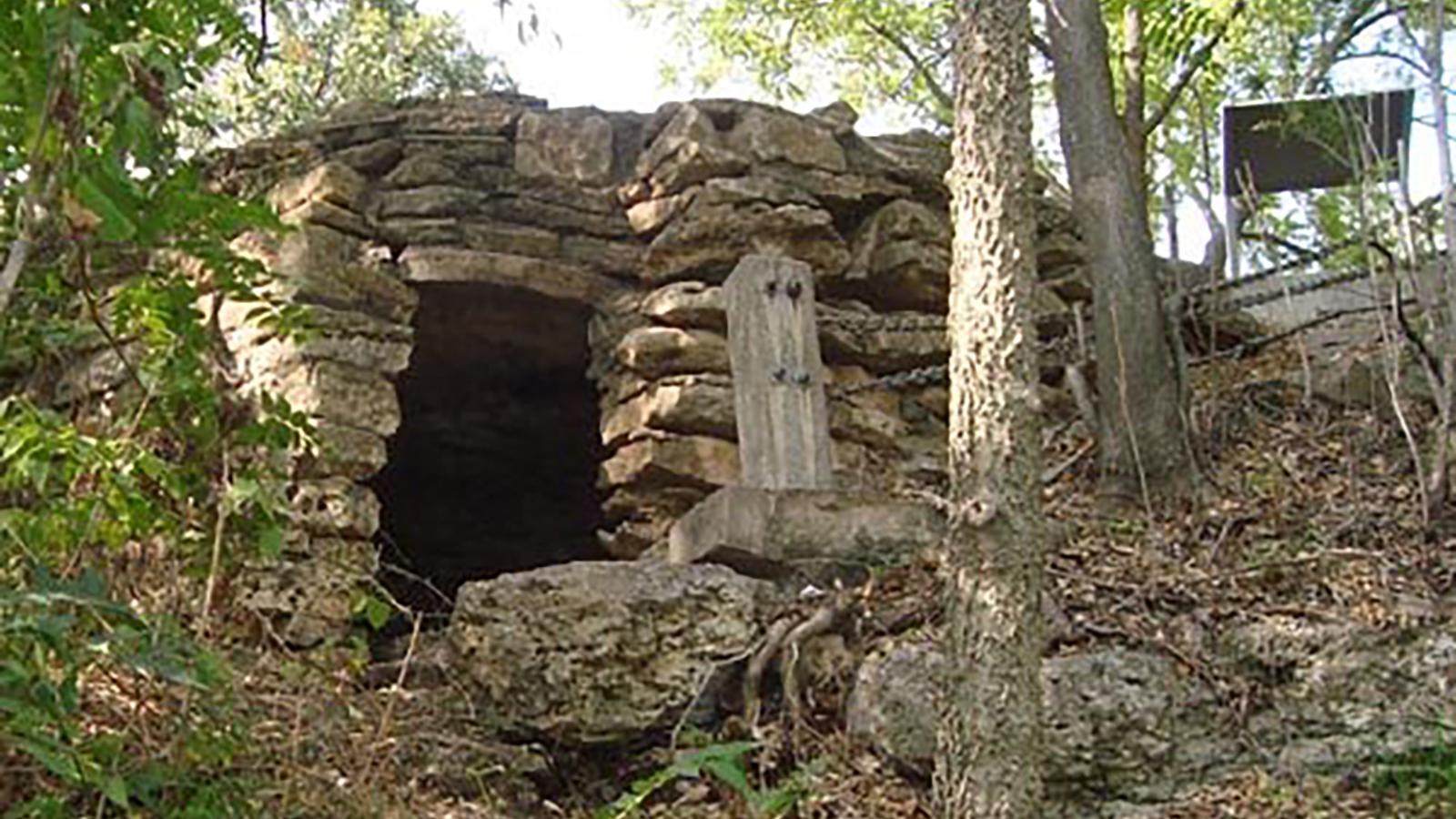 A crude stone fort in a forest.