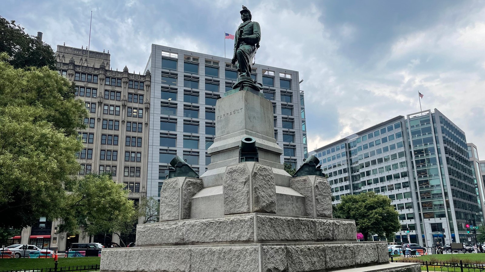 Bronze statue of a man in military uniform on a large stone pedestal