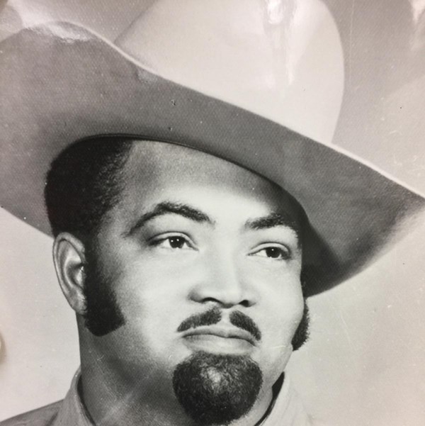 Black man with cowboy hat and trim goatee and mustache.