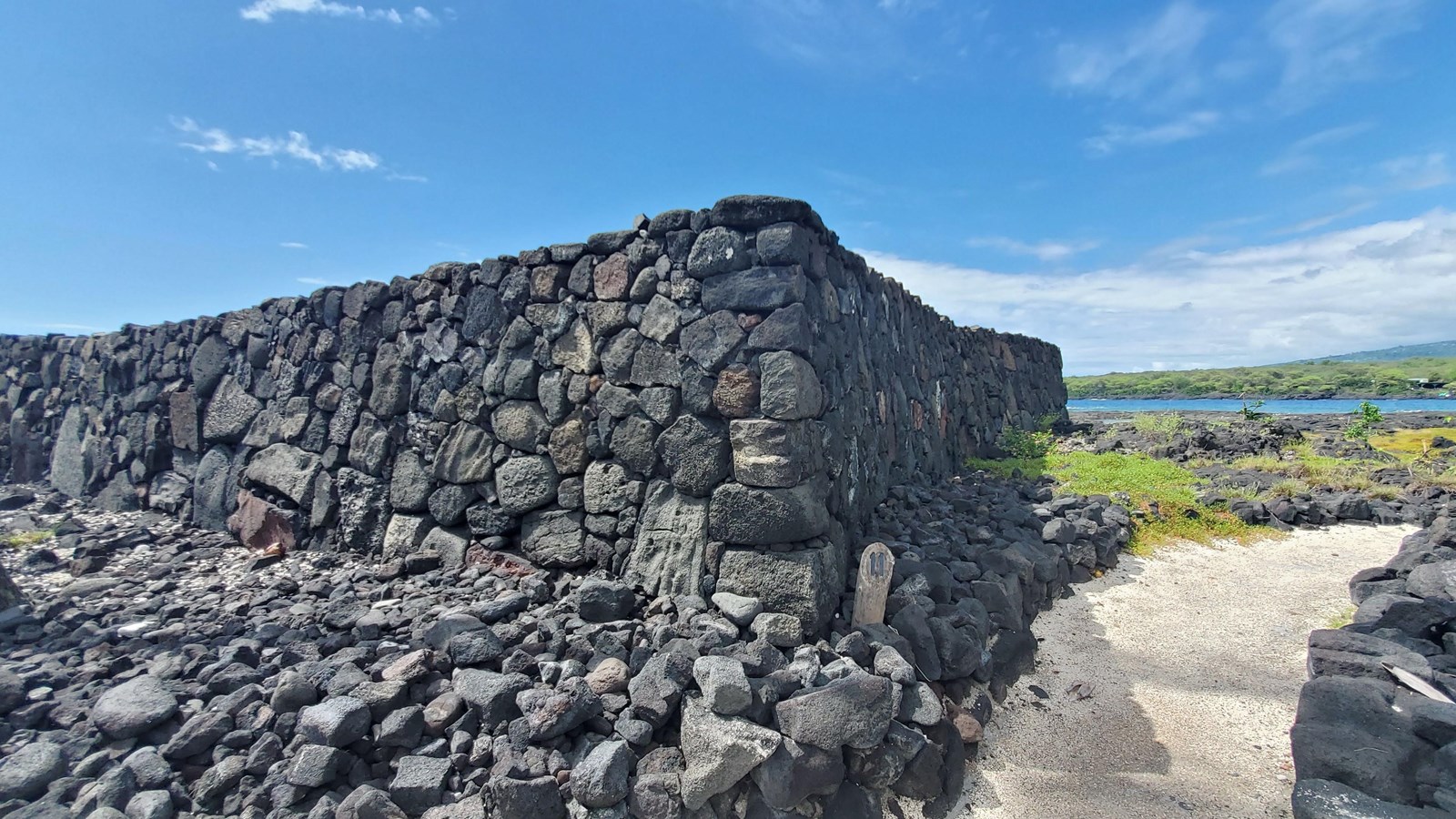 A large rectangular stacked-stone platform approximately 50 feet by 100 feet by 10 feet high. 