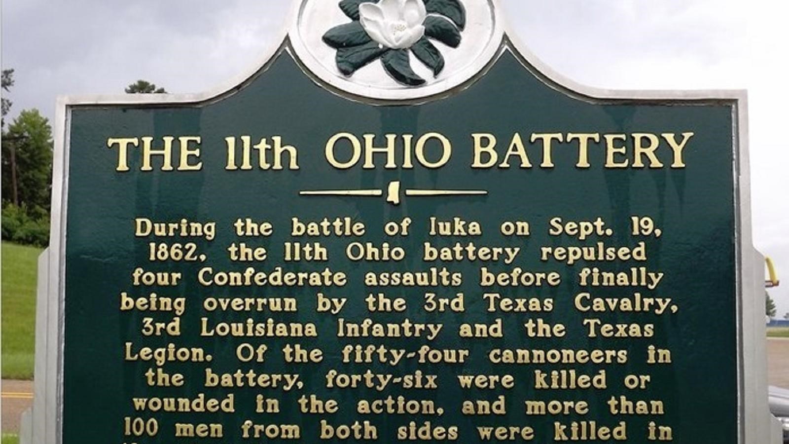 Green and silver historic marker