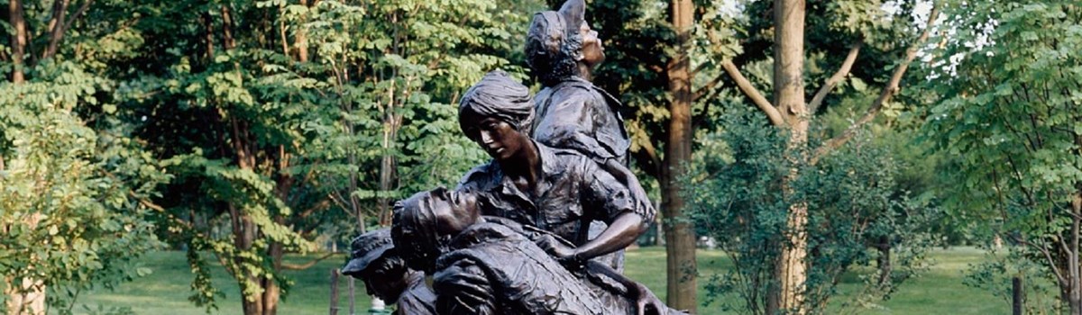 Statue of two women caring for fallen soldier.
