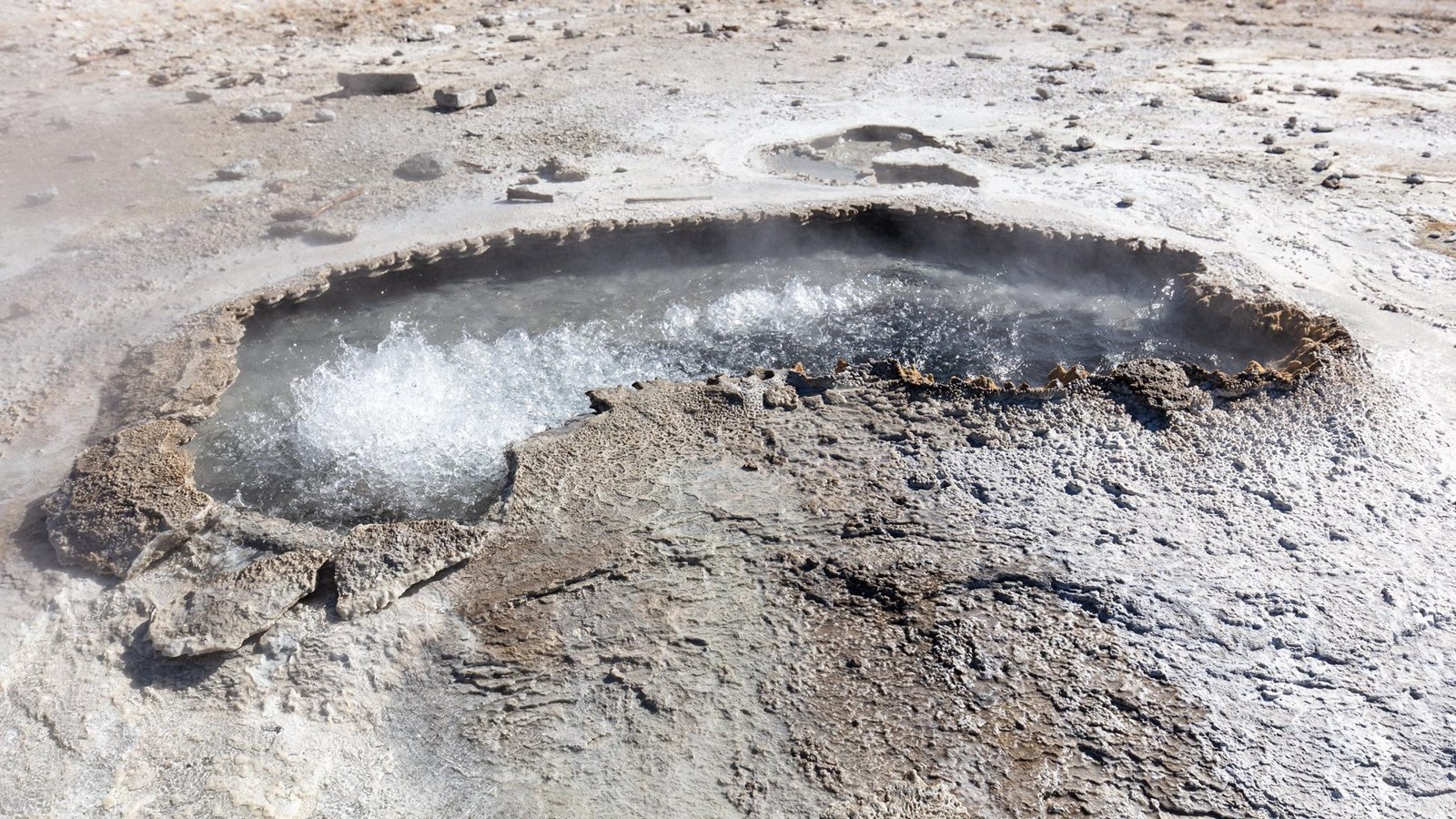 Water bubbles in a crescent-shaped hot spring.