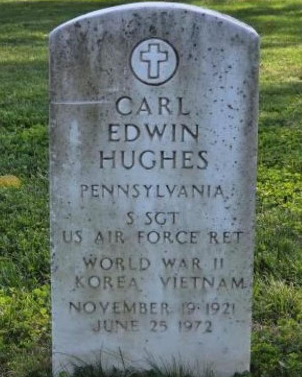 Marble headstone belonging to WWII veteran Carl Hughes. 