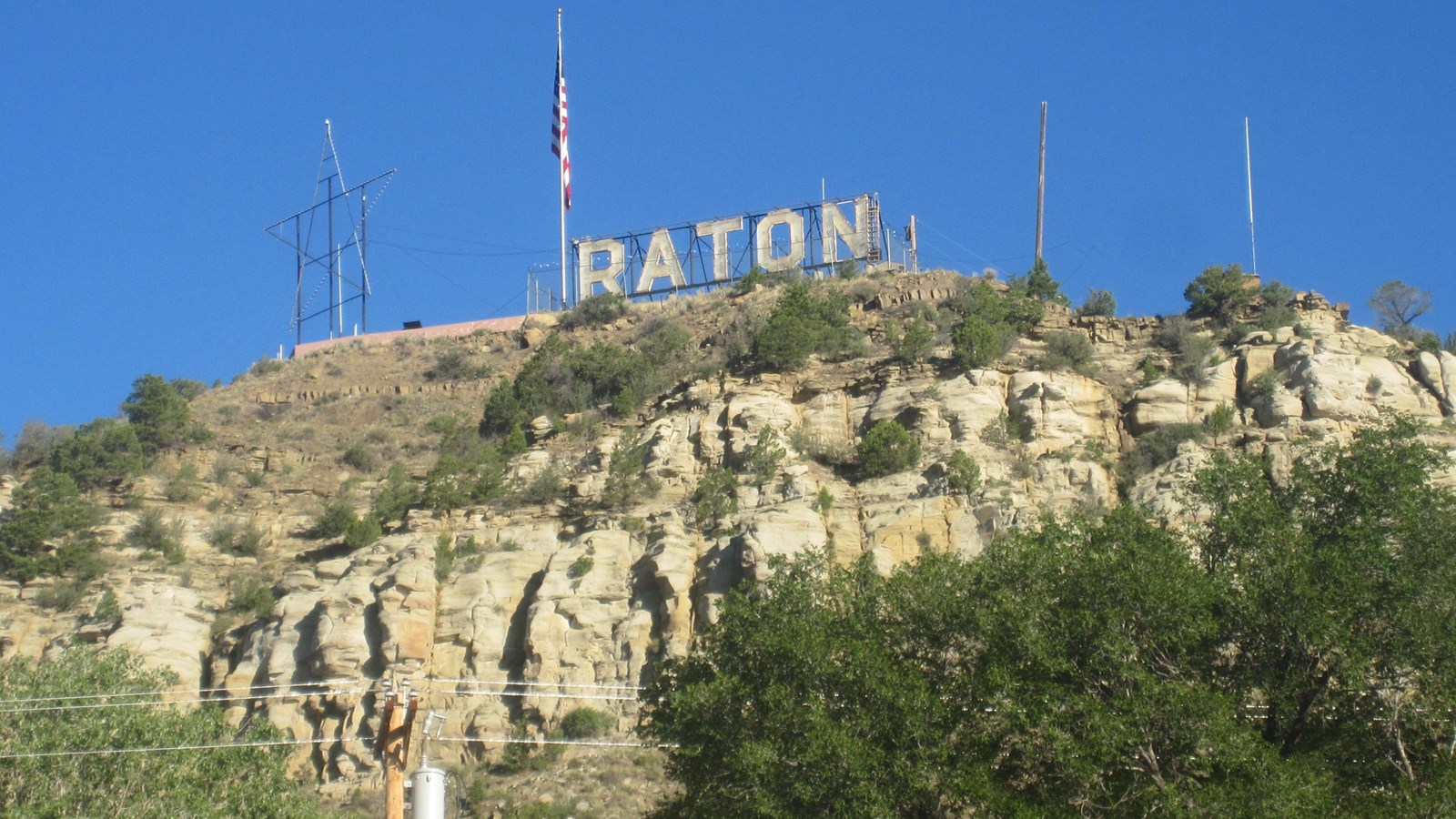 Looking up on a rocky hillside with a sign that says 